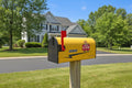 Aero Mail Covers yellow Piper Cub magnetic mailbox cover made from durable sailcloth canvas on a residential post.